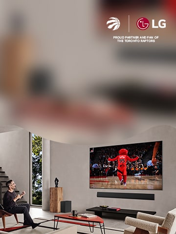 Man watches the Toronto Raptors on wall mounted OLED TV
